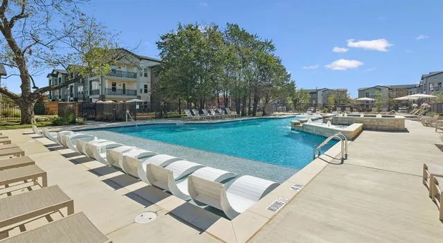 a view of a swimming pool with a lounge chairs