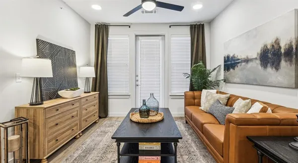 a living room with furniture and wooden floor