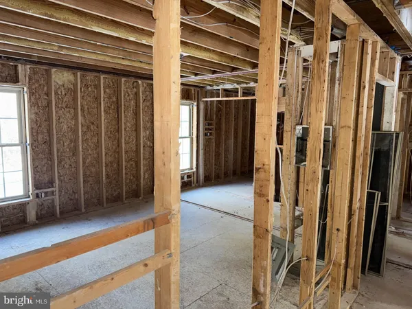 a view of a porch with a door and wooden floor