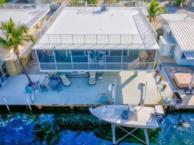 a view of a backyard with plants and outdoor seating