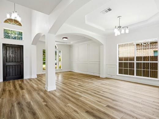 5034 West Fall Drive Midlothian, TX 76065 - Photo 5 of 40 Spacious interior featuring wood-finish flooring, high ceilings, and archway details