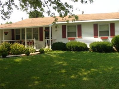 a front view of a house with a yard and plants