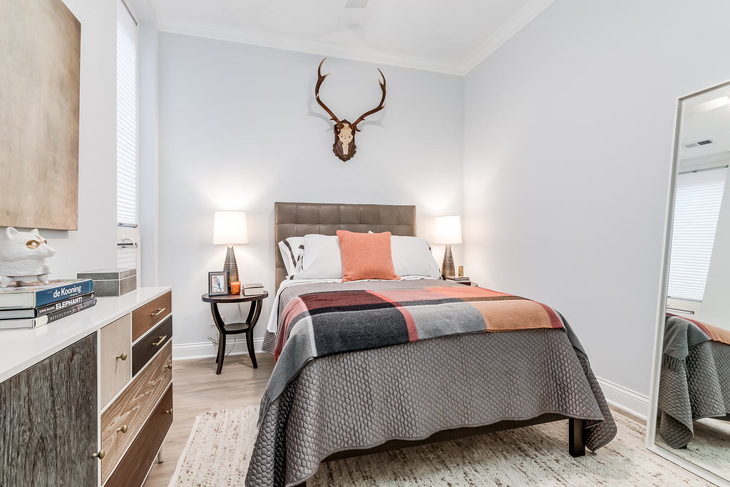 7652 Madison Street, Unit 304 Forest Park, IL 60130 - Photo 13 of 19 a bedroom with a bed and wooden floor