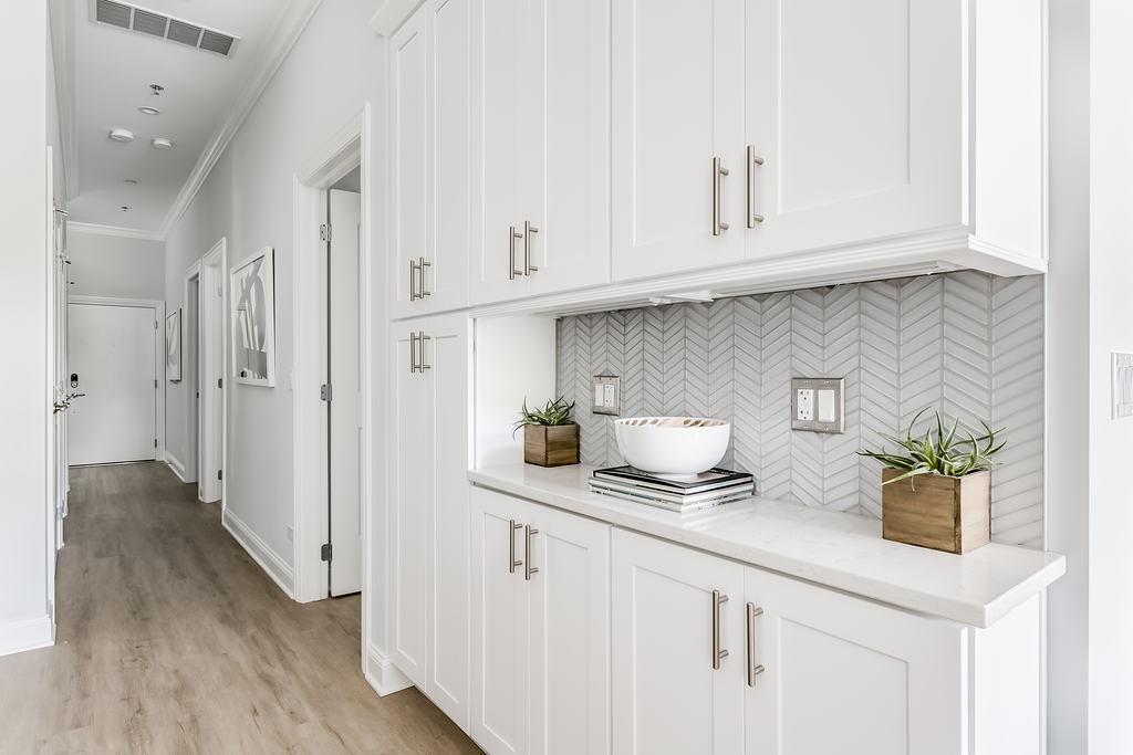 7652 Madison Street, Unit 304 Forest Park, IL 60130 - Photo 16 of 19 a kitchen with stainless steel appliances white cabinets and a wooden floor
