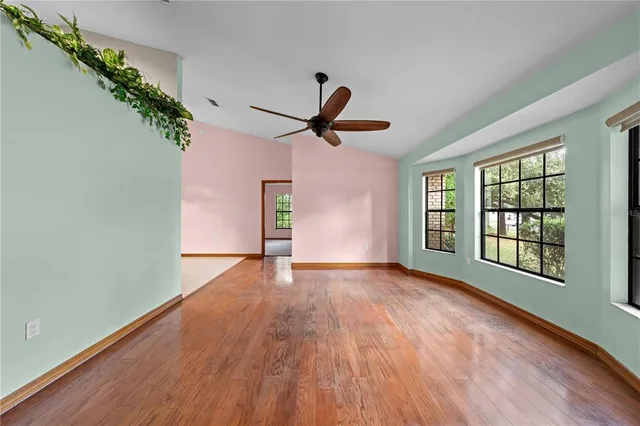a view of a livingroom with a ceiling fan and window