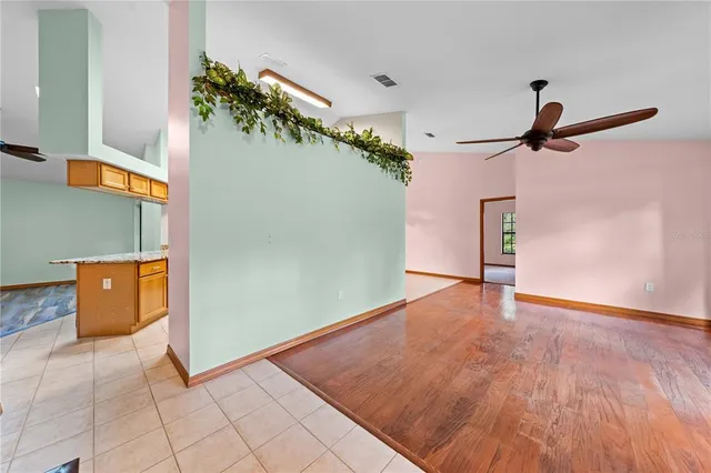 a kitchen with stainless steel appliances granite countertop a refrigerator a stove top oven and a sink with couches