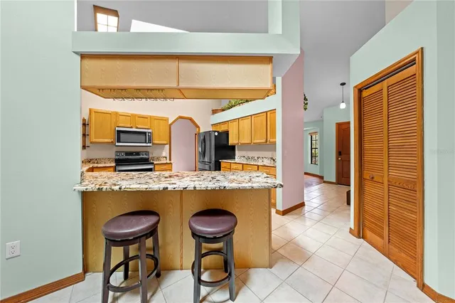 a kitchen with stainless steel appliances granite countertop a sink and cabinets