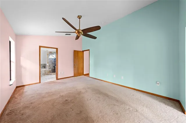a view of room with wooden floor and ceiling fan