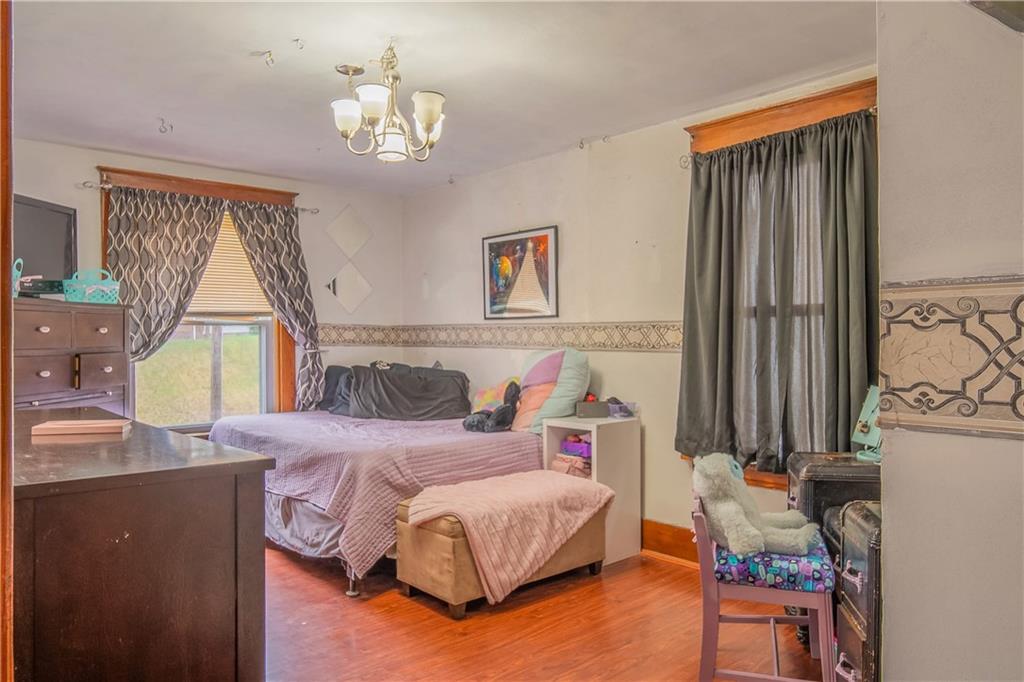 210 Wallula Avenue Butler, PA 16001 - Photo 17 of 33 a bedroom with a bed and a chandelier