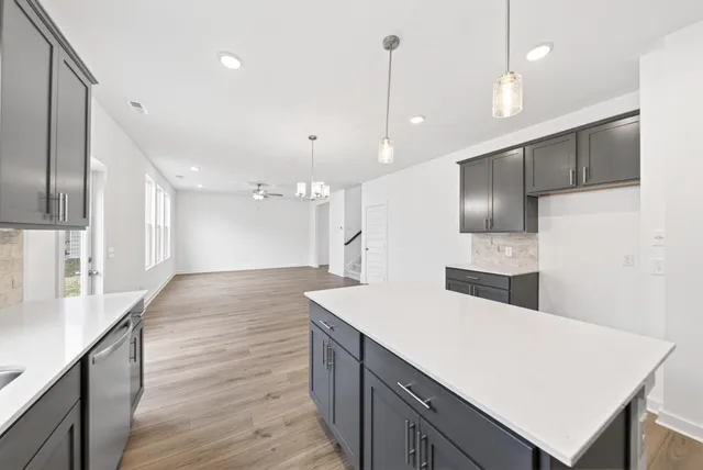 a large kitchen with kitchen island a sink stainless steel appliances and cabinets