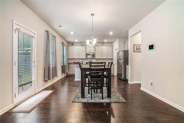 a view of a dining room with furniture window and wooden floor