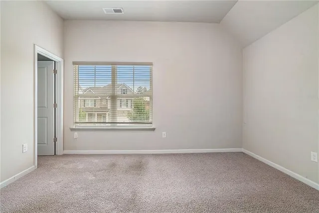 an empty room with windows and closet