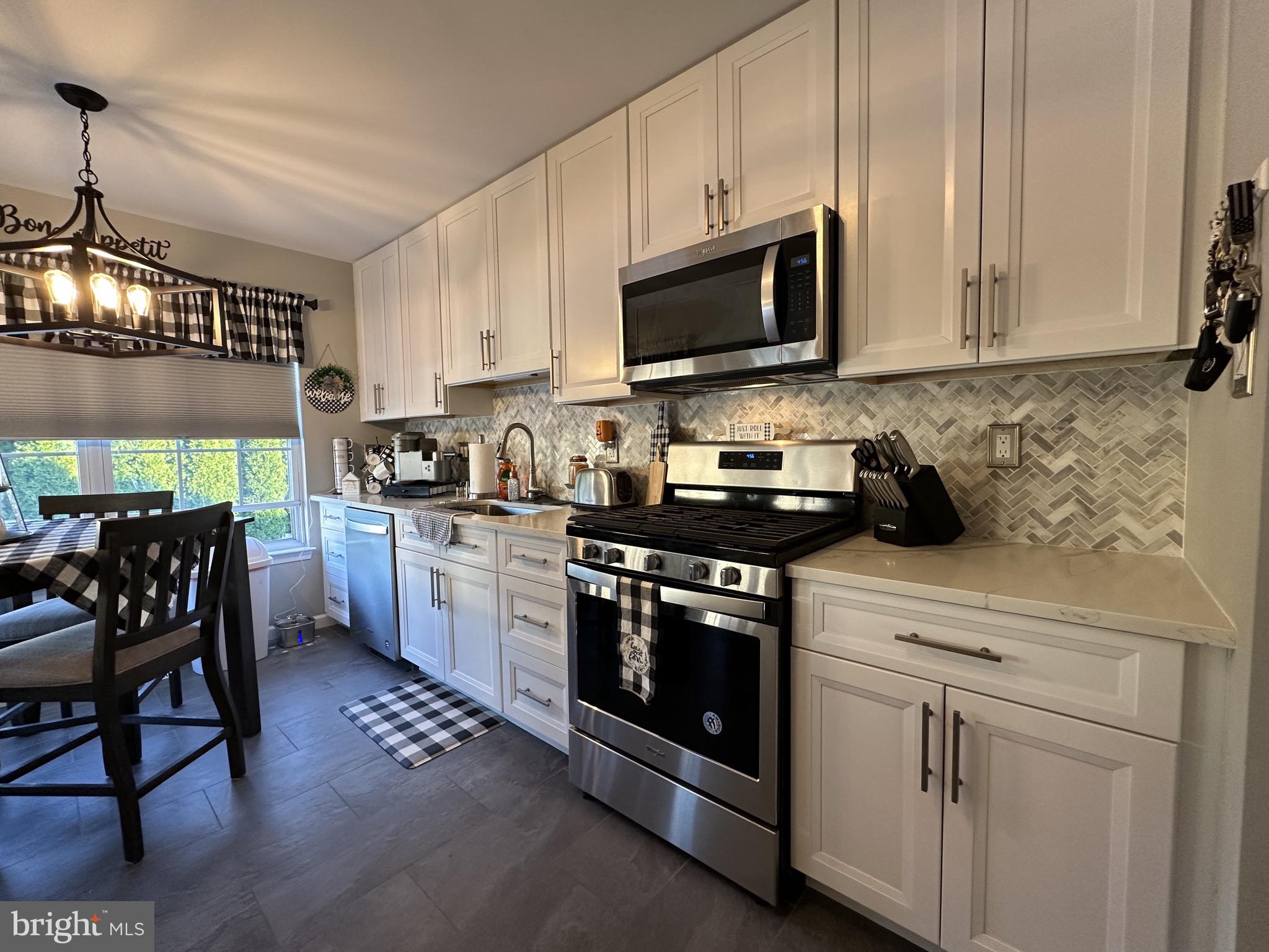 4 Sylvan Court Clementon, NJ 08021 - Photo 13 of 55 a kitchen with stainless steel appliances granite countertop a stove a sink and a microwave
