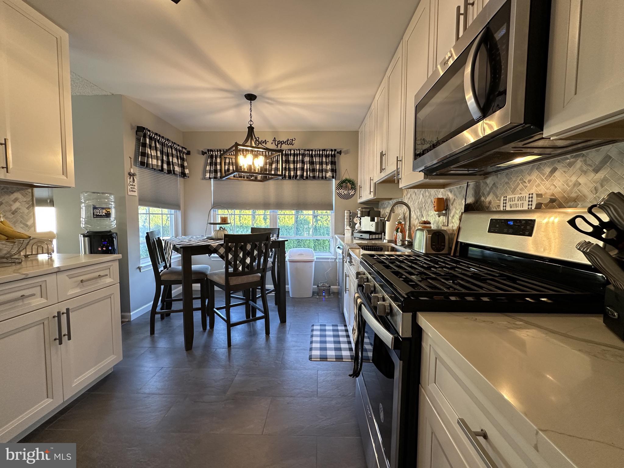 4 Sylvan Court Clementon, NJ 08021 - Photo 14 of 55 a kitchen with stainless steel appliances granite countertop a stove and a wooden floors