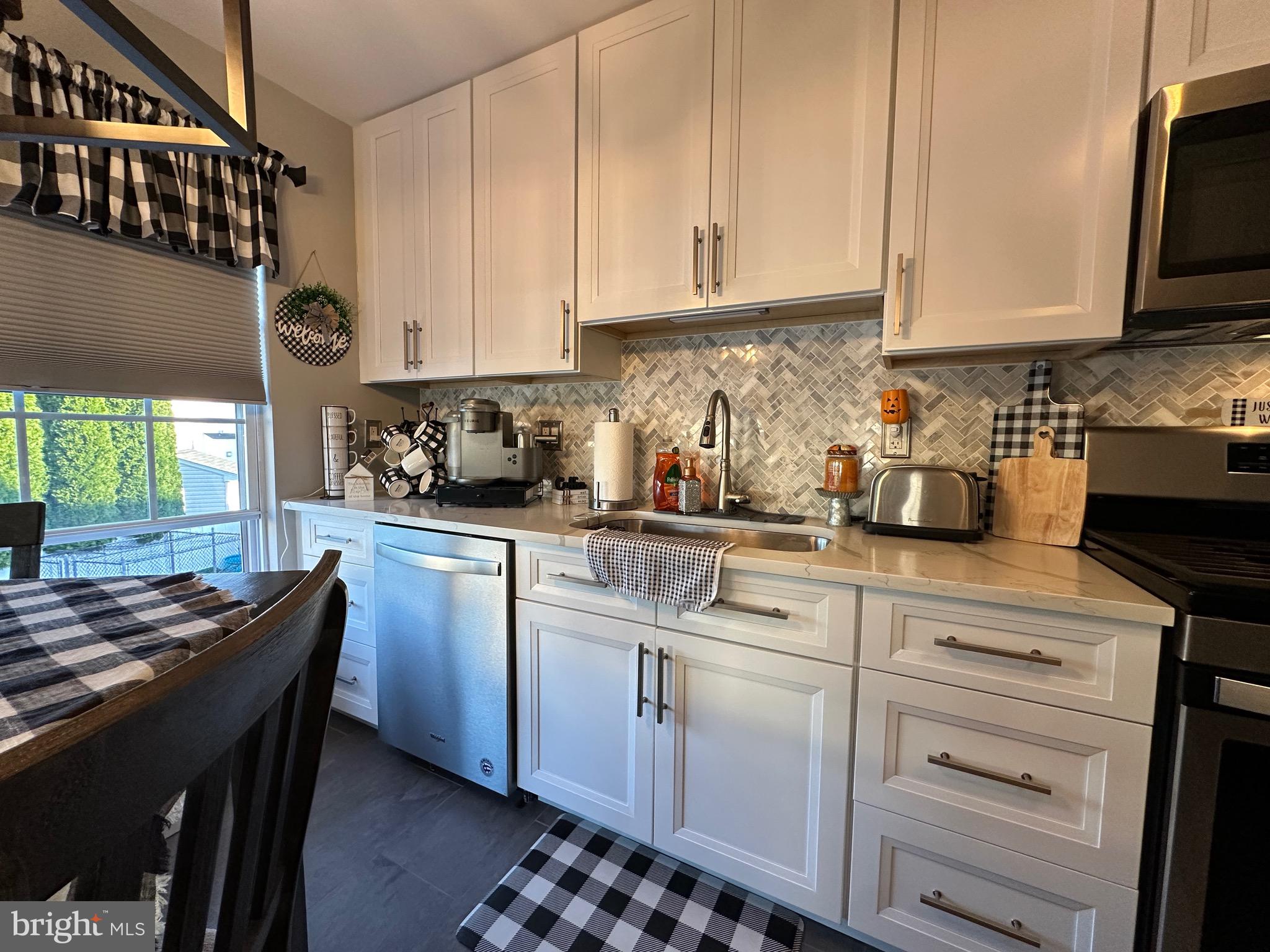 4 Sylvan Court Clementon, NJ 08021 - Photo 17 of 55 a kitchen with stainless steel appliances granite countertop a sink a stove and cabinets