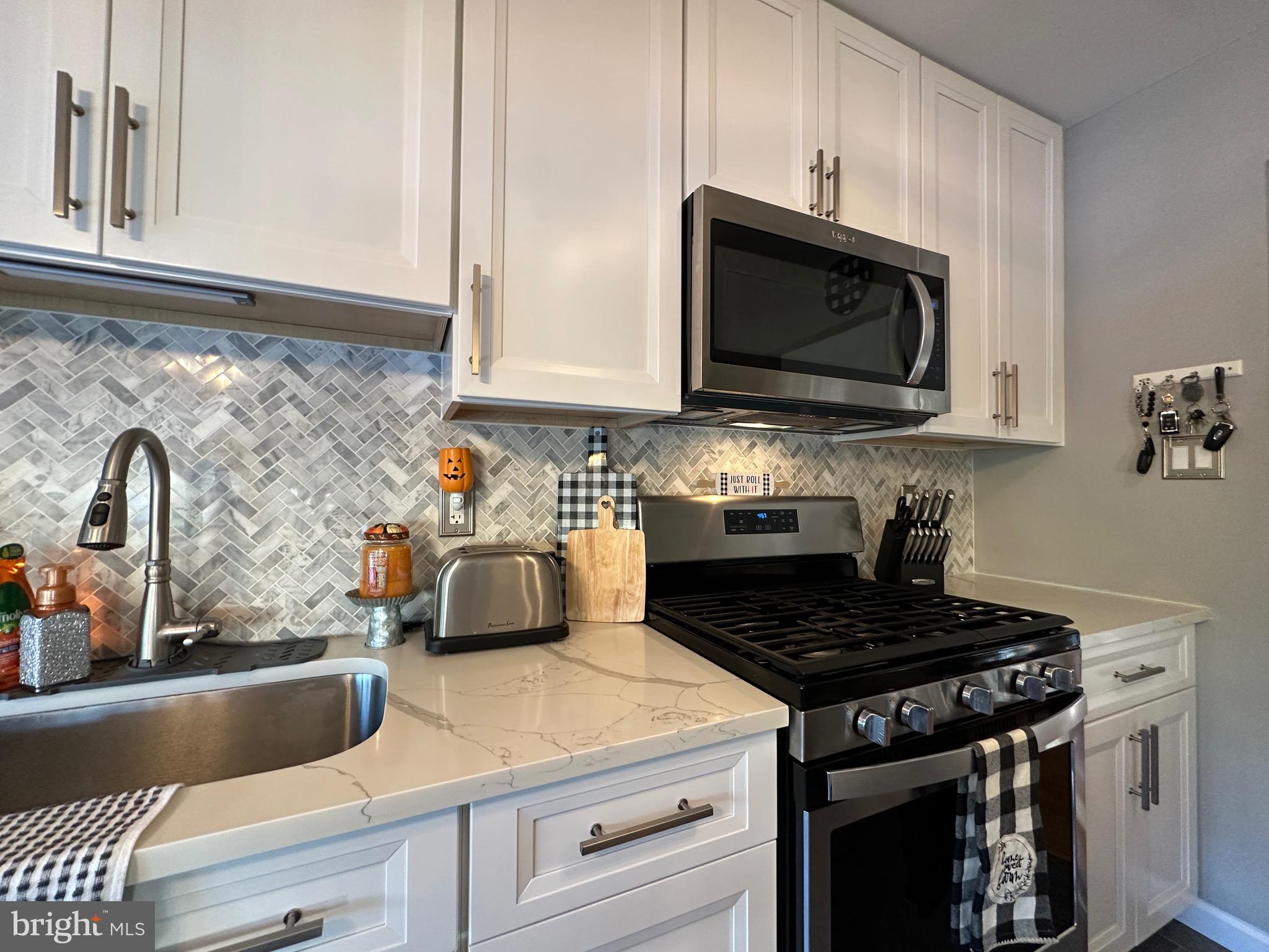 4 Sylvan Court Clementon, NJ 08021 - Photo 18 of 55 a kitchen with granite countertop a stove and a sink