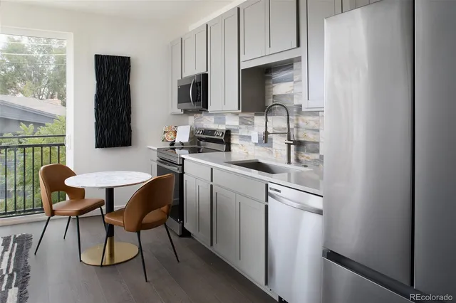 a kitchen with a sink cabinets and wooden floor