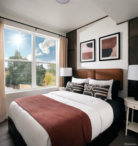 a bedroom with a large bed and a large window