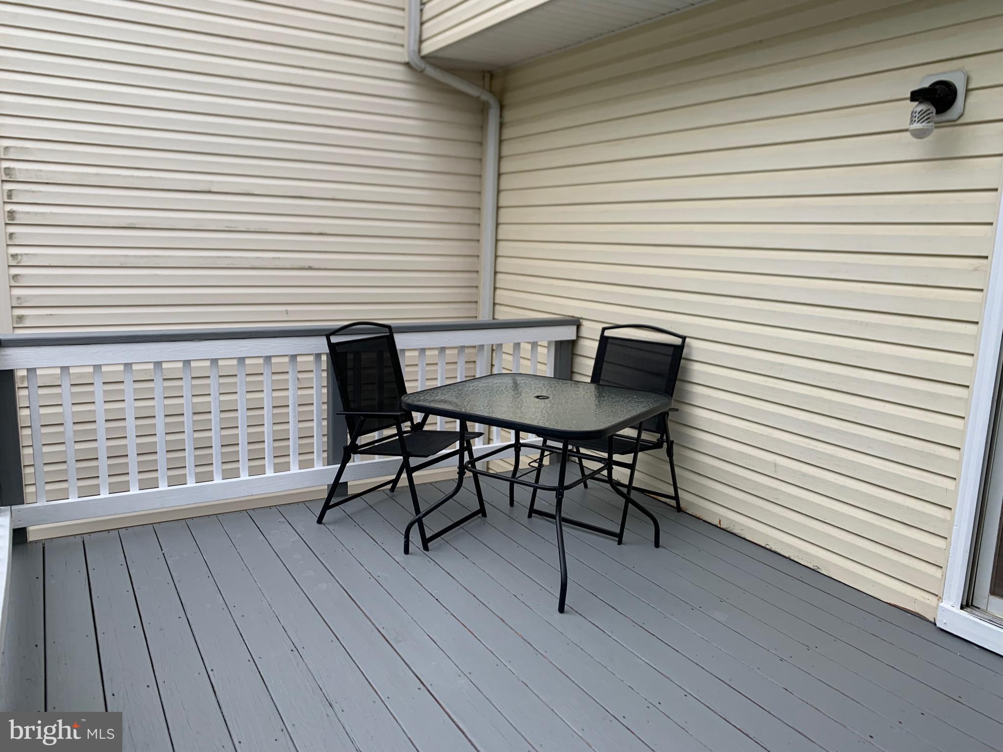 114 Sentry Ridge Smithsburg, MD 21783 - Photo 6 of 60 a view of a roof deck with table and chairs with wooden floor and floor to ceiling window
