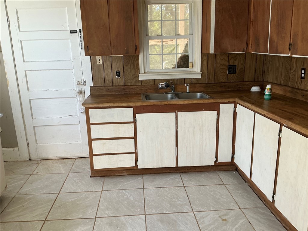 14 Ames Street Seneca, SC 29678 - Photo 14 of 16 This kitchen features classic wood cabinetry and a double sink, ready for a personal touch.