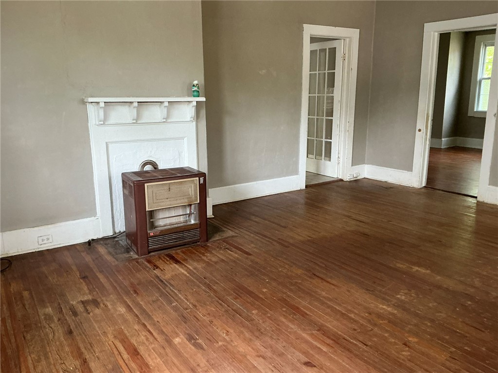 14 Ames Street Seneca, SC 29678 - Photo 2 of 16 This inviting living space features classic hardwood flooring and a charming fireplace.