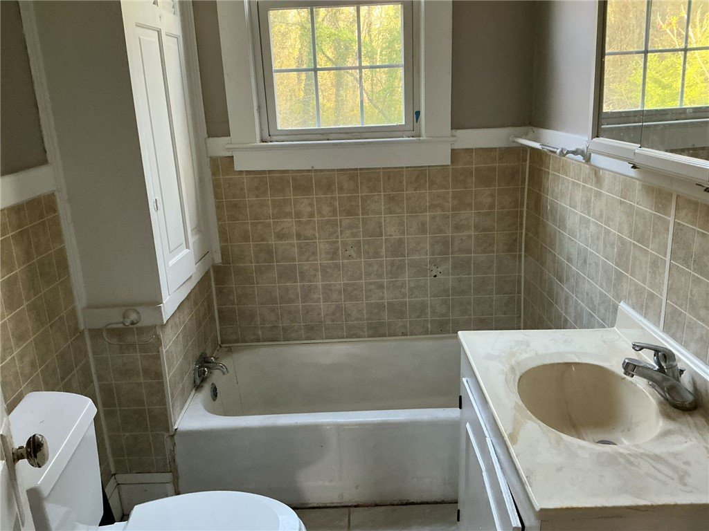 14 Ames Street Seneca, SC 29678 - Photo 4 of 7 A well-appointed bathroom features a practical vanity and a classic tub, perfect for daily routines.