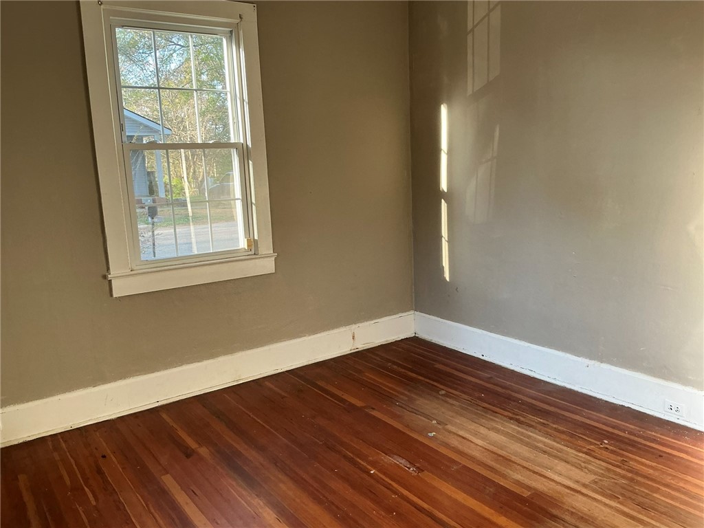 14 Ames Street Seneca, SC 29678 - Photo 5 of 7 This bright room features beautiful hardwood flooring, offering a comfortable living space.