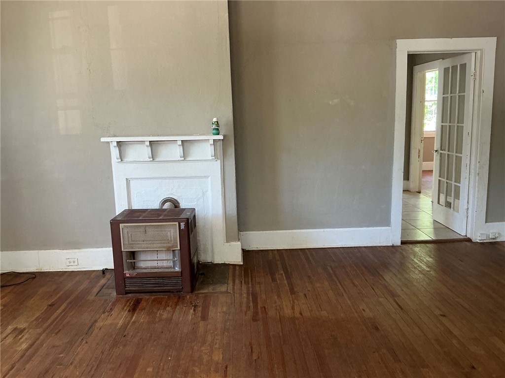 14 Ames Street Seneca, SC 29678 - Photo 5 of 16 This inviting space features classic hardwood flooring and a charming fireplace.