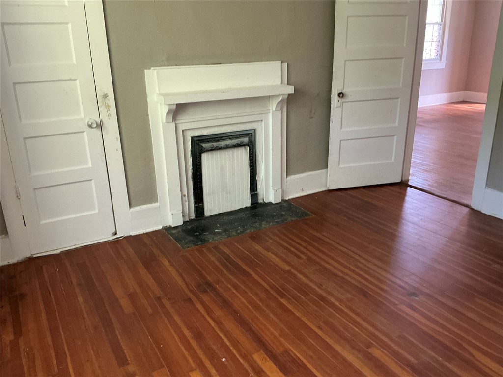 14 Ames Street Seneca, SC 29678 - Photo 6 of 16 This interior space features hardwood floors and a classic fireplace.