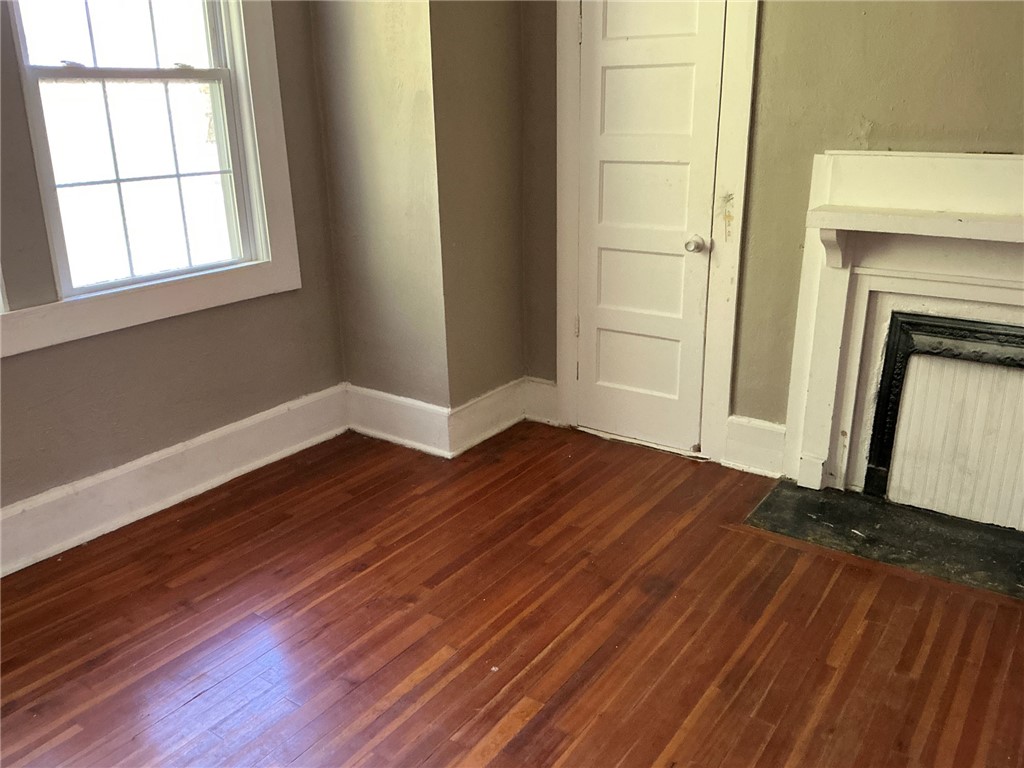 14 Ames Street Seneca, SC 29678 - Photo 9 of 16 This inviting room features warm wood flooring and a classic fireplace, creating a cozy atmosphere.