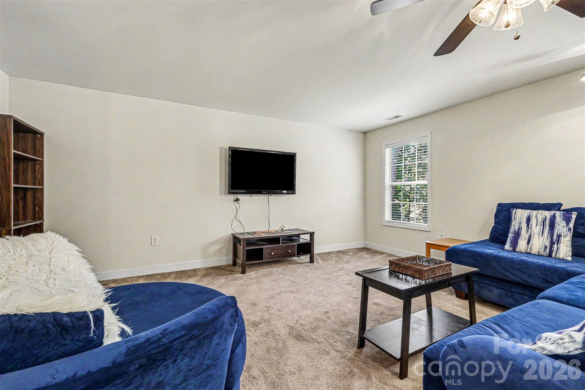 3035 Proverbs Court Monroe, NC 28110 - Photo 16 of 30 a living room with furniture and a flat screen tv