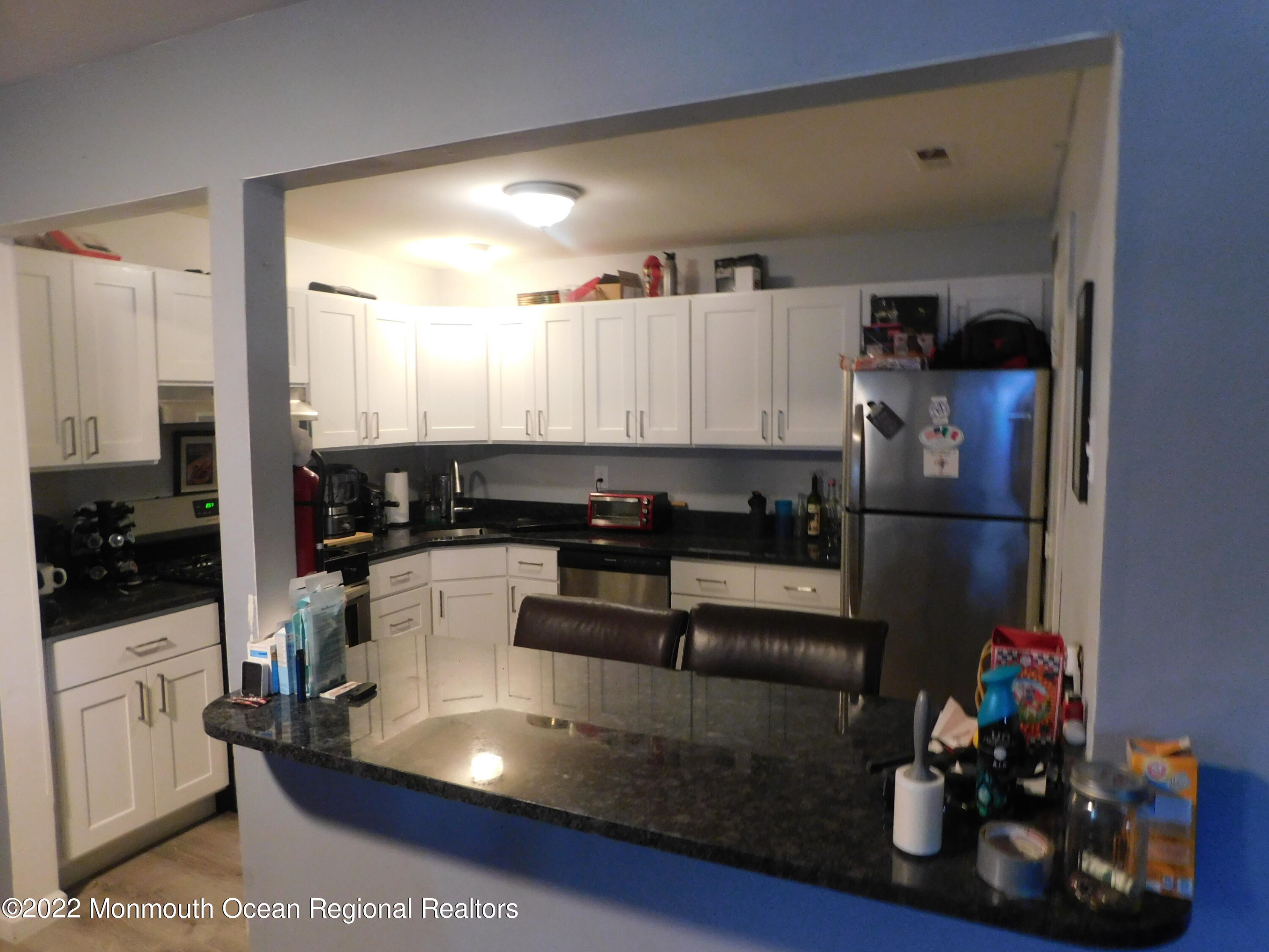 716 Zlotkin Circle, Unit 4 Freehold, NJ 07728 - Photo 3 of 10 a kitchen with a refrigerator and a stove top oven
