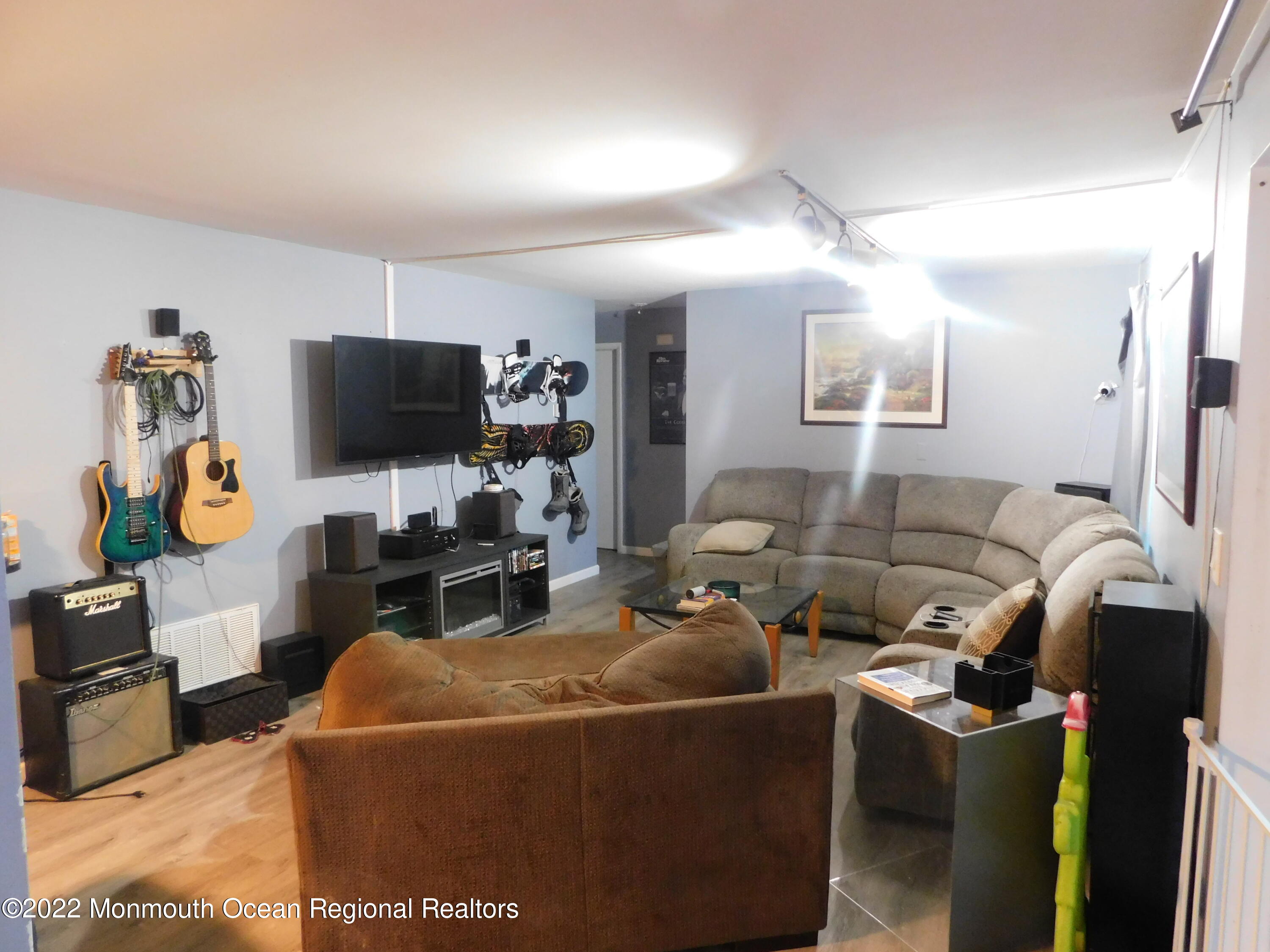 716 Zlotkin Circle, Unit 4 Freehold, NJ 07728 - Photo 6 of 10 a living room with furniture a flat screen tv and a view of kitchen
