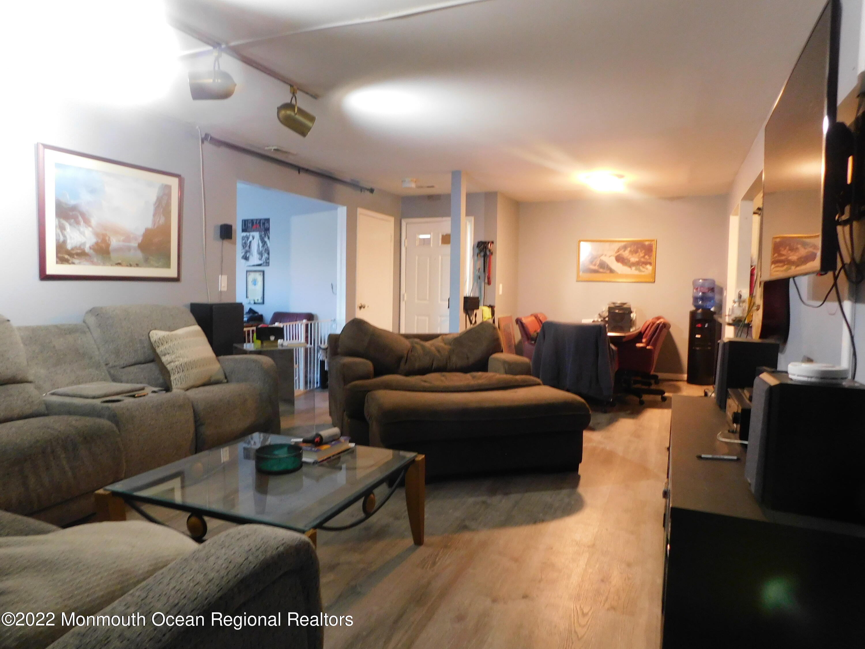 716 Zlotkin Circle, Unit 4 Freehold, NJ 07728 - Photo 7 of 10 a living room with furniture a rug and a flat screen tv