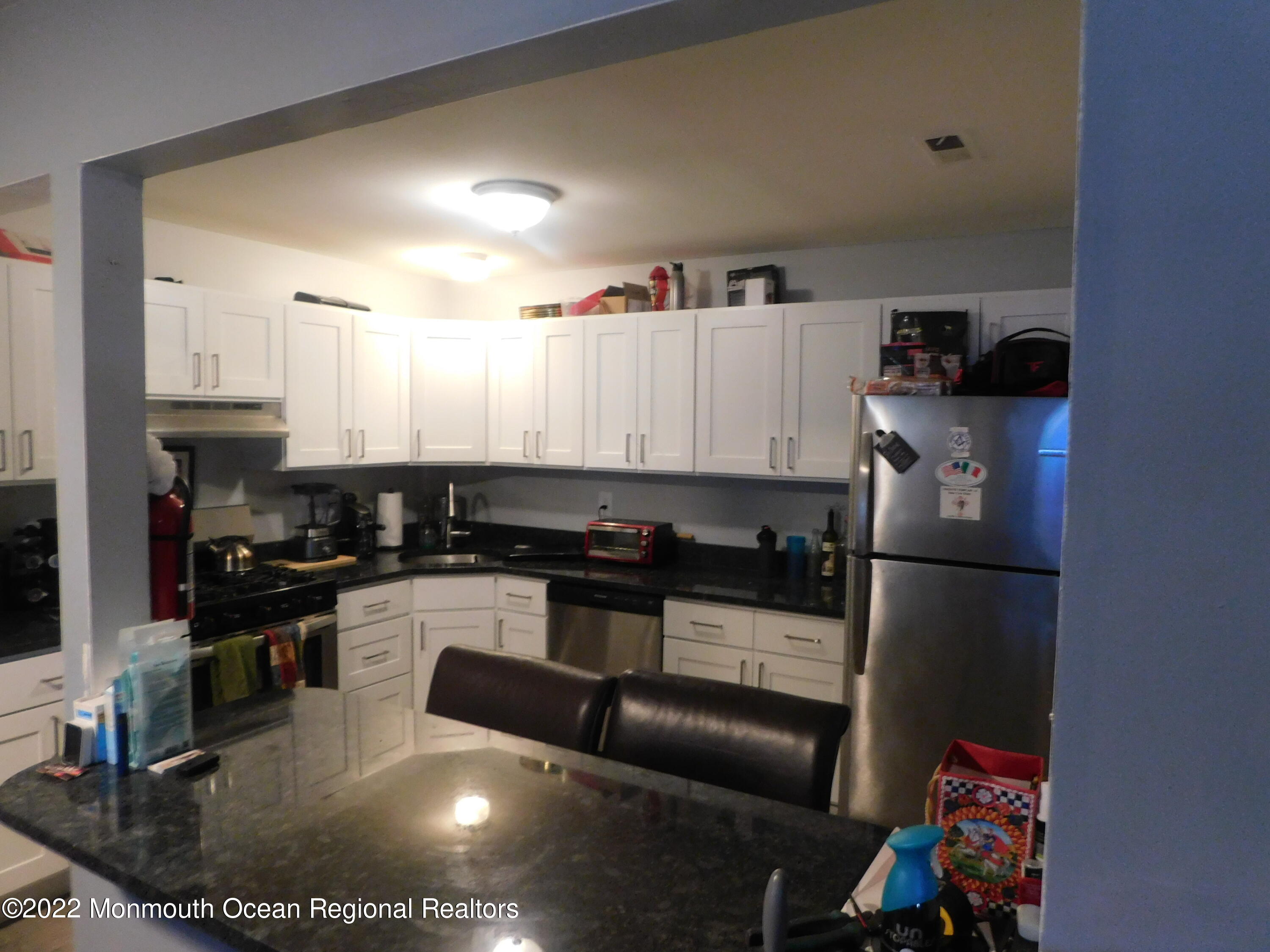 716 Zlotkin Circle, Unit 4 Freehold, NJ 07728 - Photo 8 of 10 a kitchen with a sink stainless steel appliances and cabinets