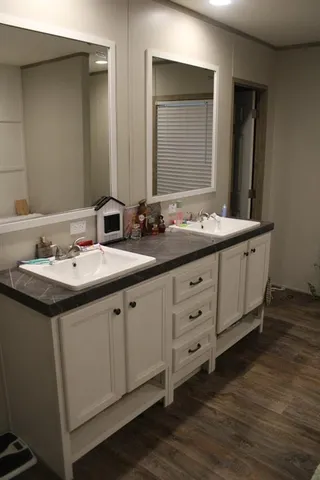 a bathroom with a double vanity sink and mirror