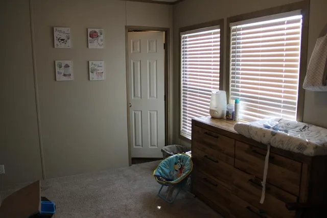 a bathroom with a granite countertop sink and a large mirror