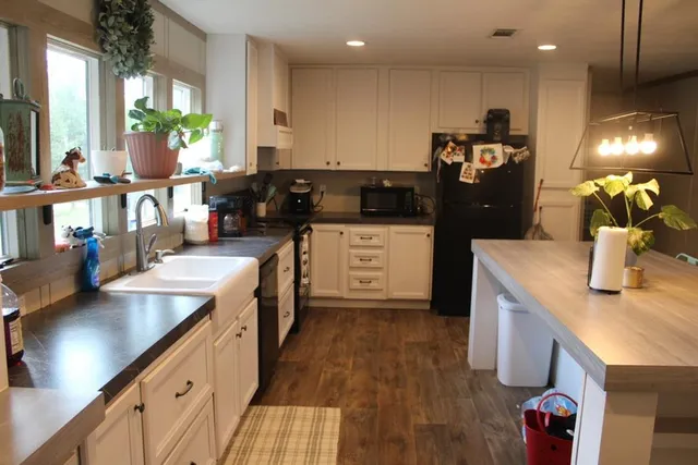 a kitchen with a sink stove and wooden cabinets