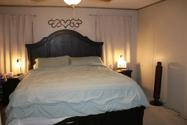 a bedroom with a bed and a mirror