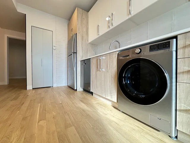 a view of a hallway with washer and dryer