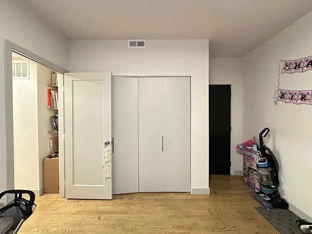 a view of a bedroom with a bed and closet