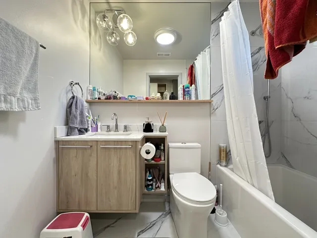 a bathroom with a toilet a sink and a mirror