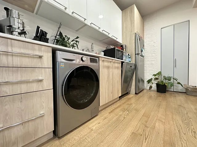 a view of a storage & utility room with a sink