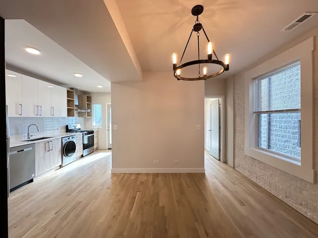 a kitchen with stainless steel appliances a stove and a window
