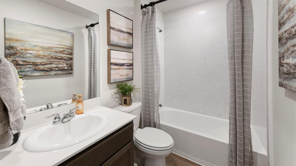 1671 Mantle Road Crandall, TX 75114 - Photo 22 of 24 Bathroom featuring a single vanity with an integrated sink, chrome faucet, and a dark wood-finish cabinet