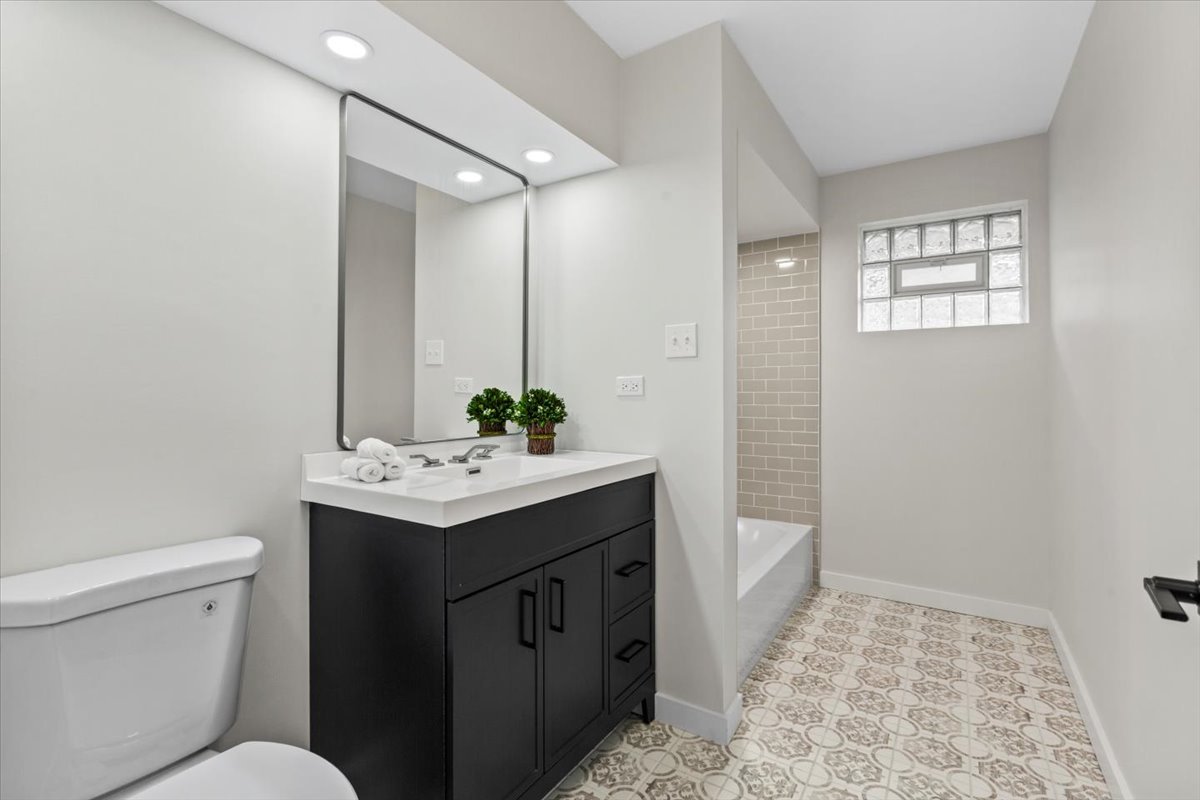 10206 South St Louis Avenue Evergreen Park, IL 60805 - Photo 19 of 33 a bathroom with a sink toilet and shower