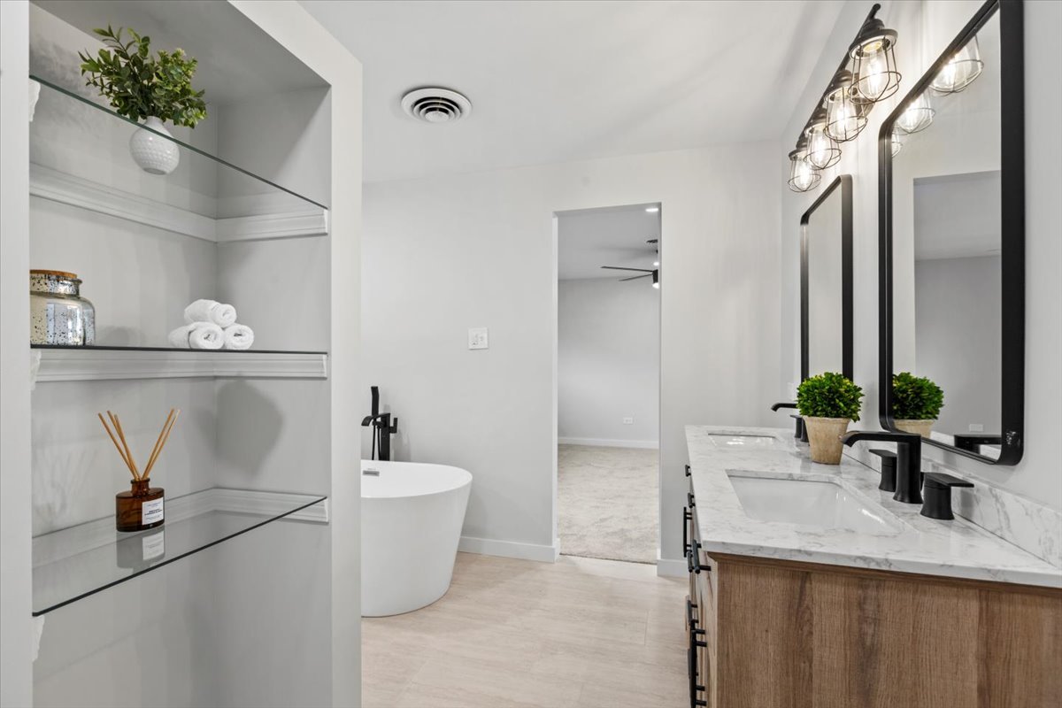 10206 South St Louis Avenue Evergreen Park, IL 60805 - Photo 23 of 33 a bathroom with a granite countertop sink a toilet and a mirror
