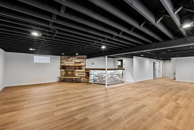 a view of empty room with wooden floor and racks