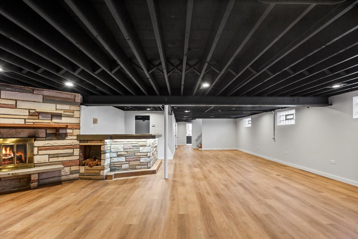 10206 South St Louis Avenue Evergreen Park, IL 60805 - Photo 28 of 33 a view of empty room with wooden floor and racks