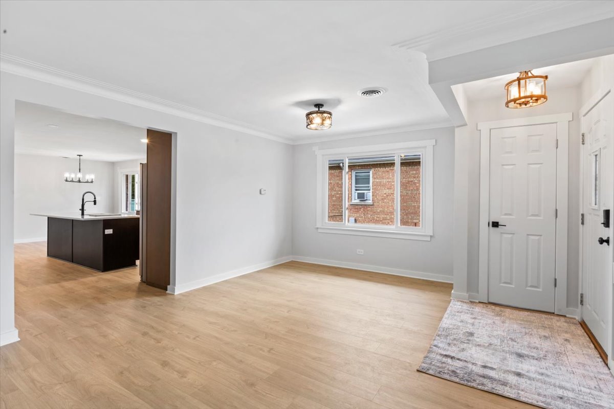 10206 South St Louis Avenue Evergreen Park, IL 60805 - Photo 7 of 33 wooden floor in an empty room with a window